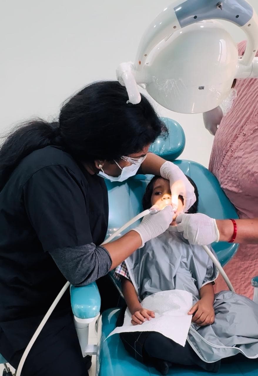 A young child at a gentle, friendly pediatric dental check-up
